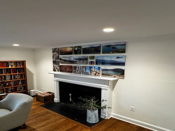 Gallery wall of photos mounted under  plexiglass  in a house in Bethesda MD