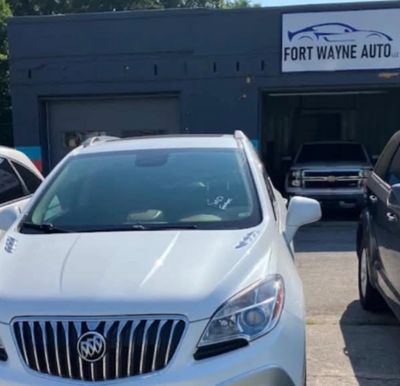 Silver Buick SUV parked in front of Fort Wayne Auto shop.