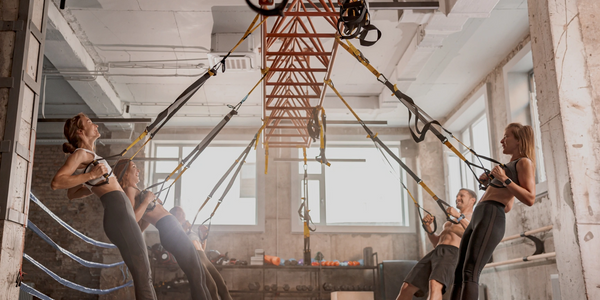 people of various ages and ethnicities working hard in functinal fitness in a luxury fitness club

