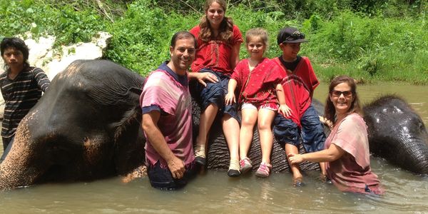 Stephanie and family washing elephants in Thailand