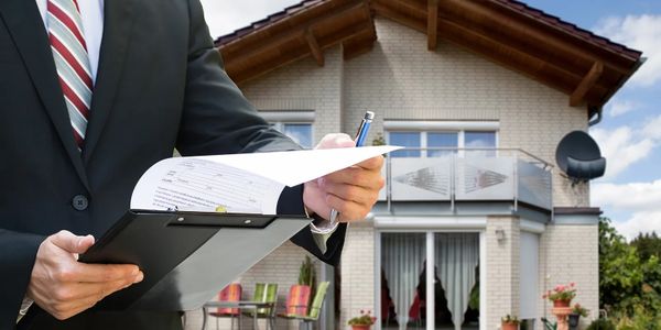 A real estate agent in front of a house