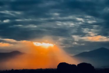 Calm evening landscape with soft clouds scattered across the horizon