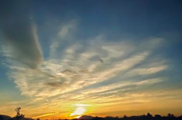 Peaceful evening sky with scattered clouds along the horizon