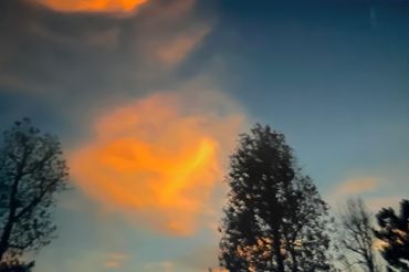 Soft evening sky with scattered clouds creating a peaceful view