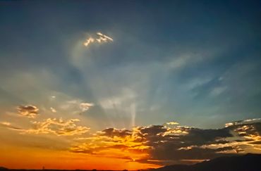 Serene sunset sky with light clouds drifting over the horizon