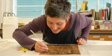 Rebecca Bissonnet conserving an African plant fibre mat.