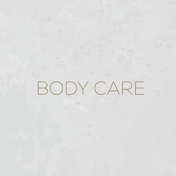 Minimalist sign reading 'BODY CARE' on a light, textured background.