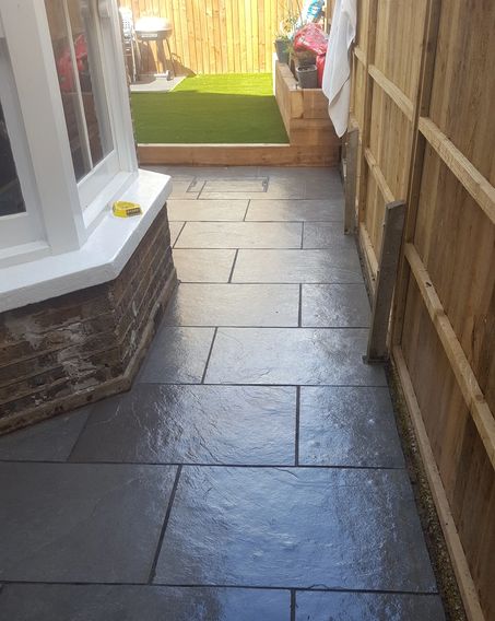 Black slate slabs and artificial grass 