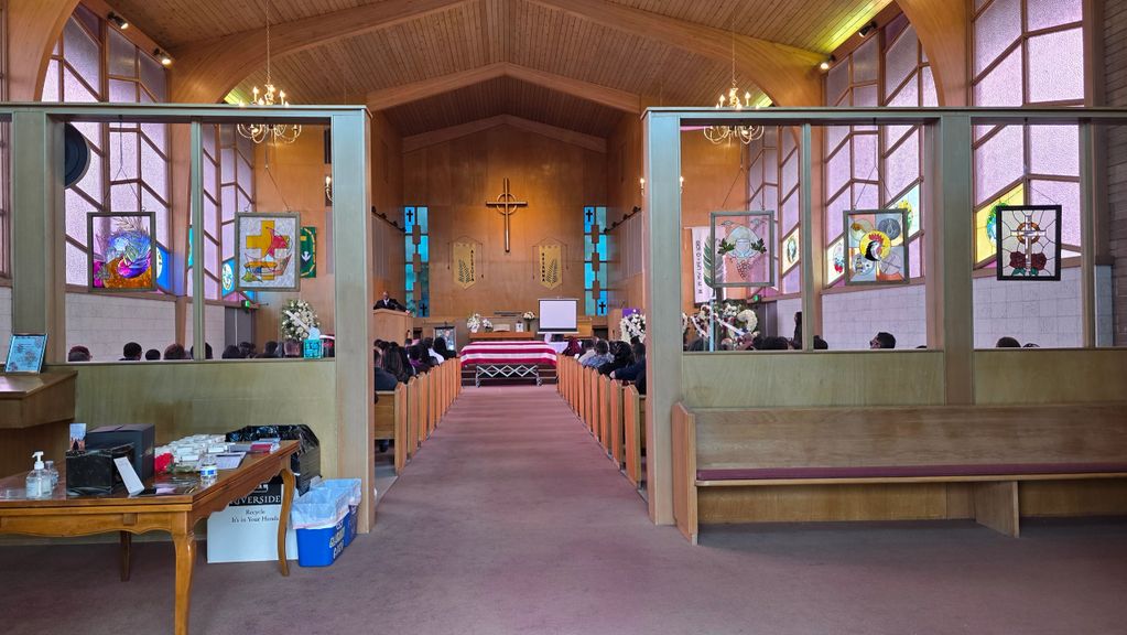 Interior of a church with a congregation attending a service.