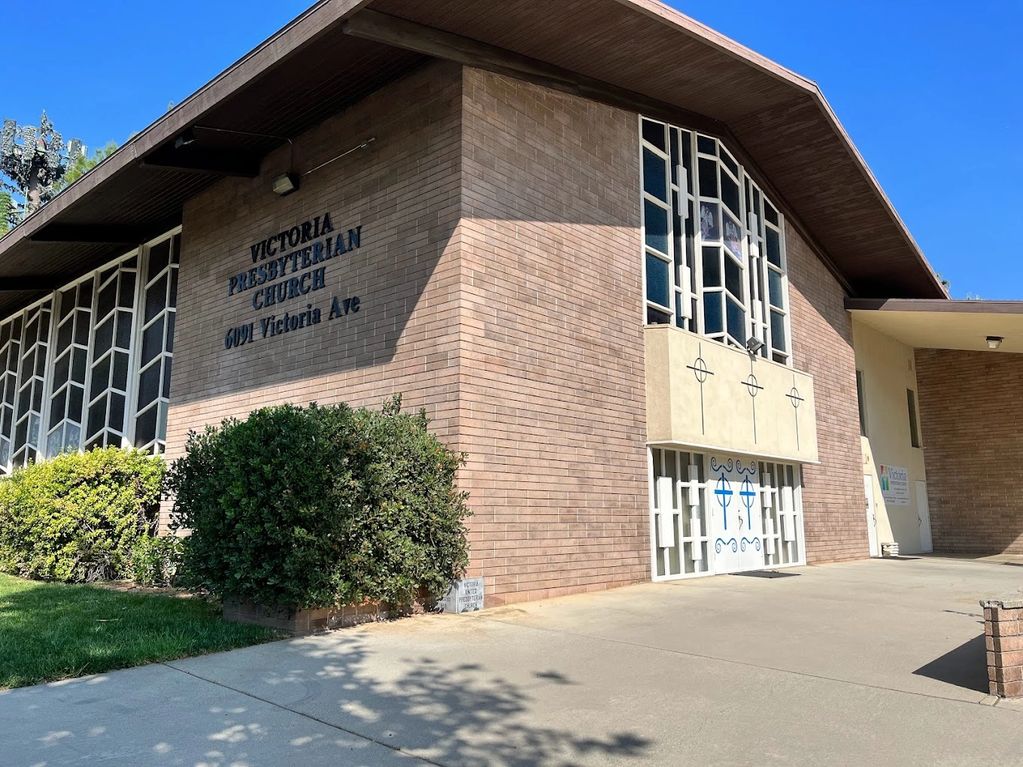 Exterior view of Victoria Presbyterian Church with brick walls and stained glass windows.