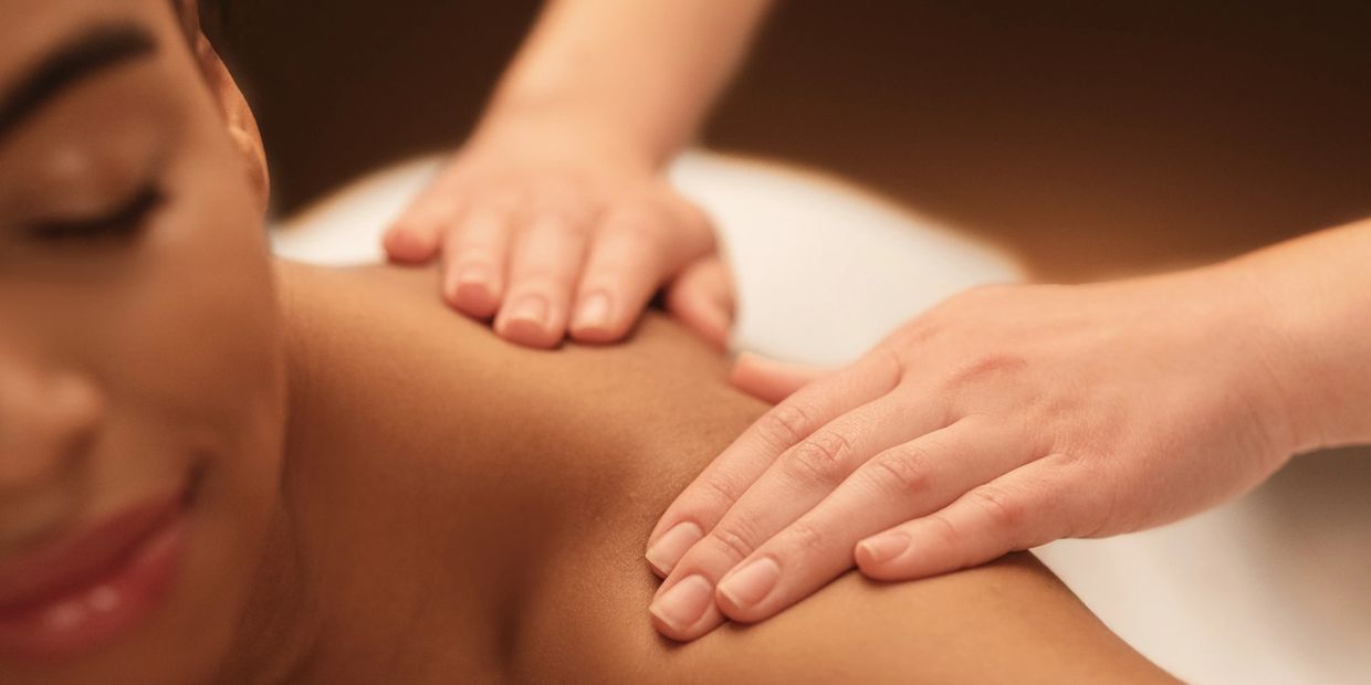 Person receiving a relaxing shoulder massage.