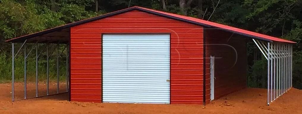 Large red metal barn with white garage door and side supports.