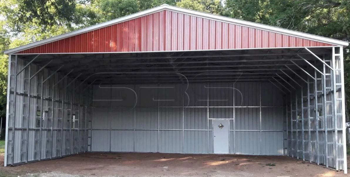 Large open metal storage building with red and gray panels.
