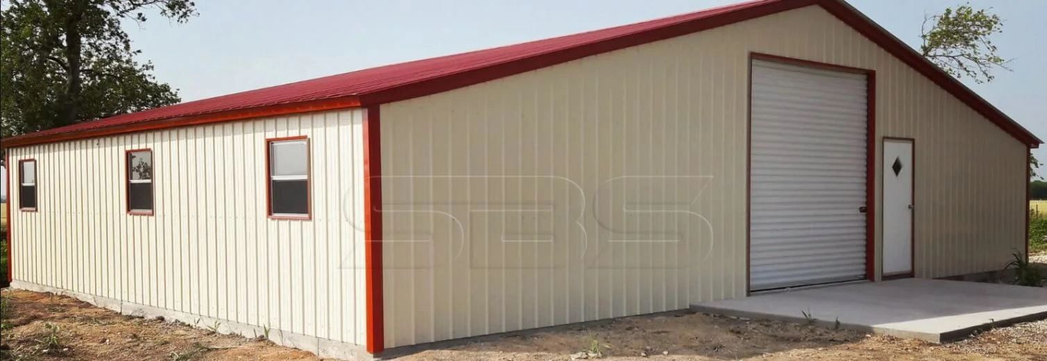 Metal building with beige walls and red roof.