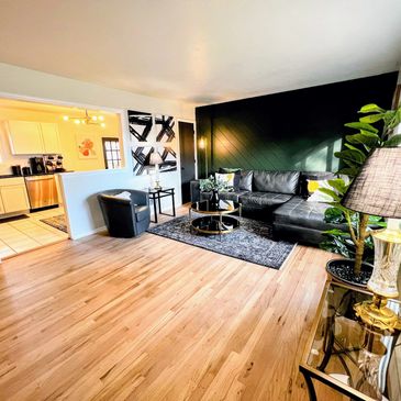 Family room with custom shiplap wall, modern decor that leads into the kitchen. 