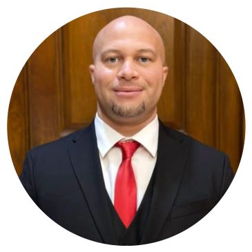 Portrait of a man in a suit with a red tie.