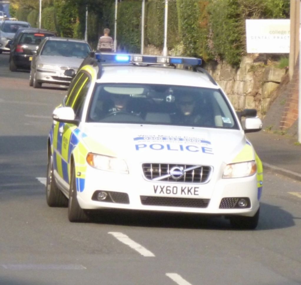 Police car with flashing lights on a street.
