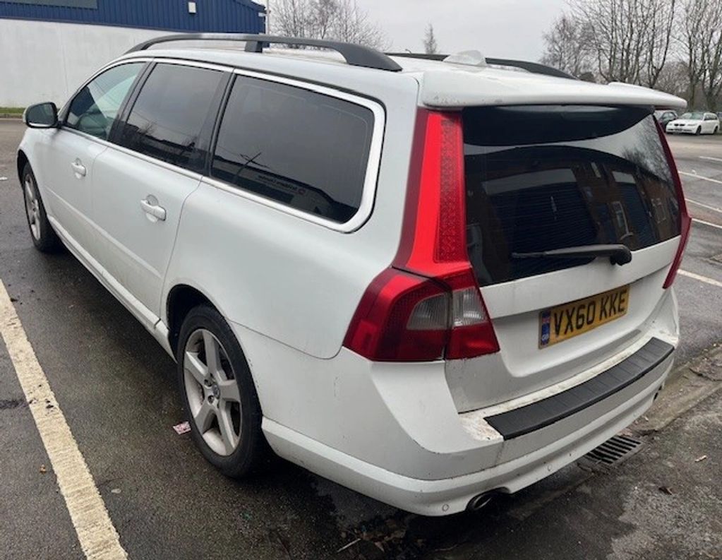 White station wagon parked on the street.