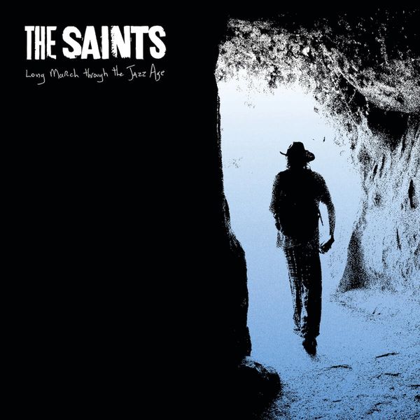 Silhouette of a man walking through a cave entrance with album title and band name.