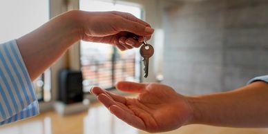 Handing over a key in a bright, modern room.