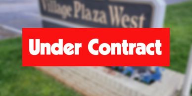 Sign showing 'Under Contract' in front of Village Plaza West.