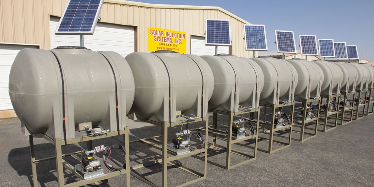 Solar Injection Systems SunPumper systems in a row outside a factory.