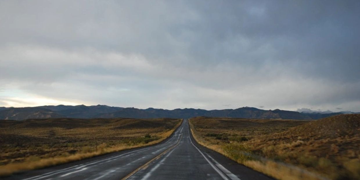 Empty road across a Wyoming desert landscape.
