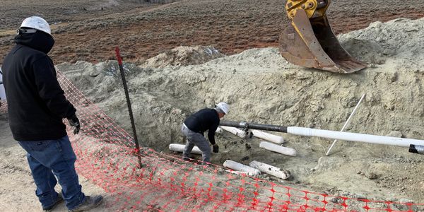 Wyoming Service and Supply Technicians installing cathodic protection on a pipeline in desert.