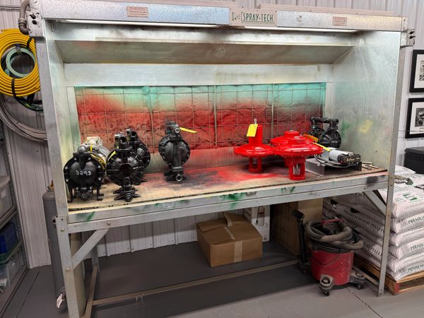 Overhauled pumps in the in-house paint booth after being repainted.