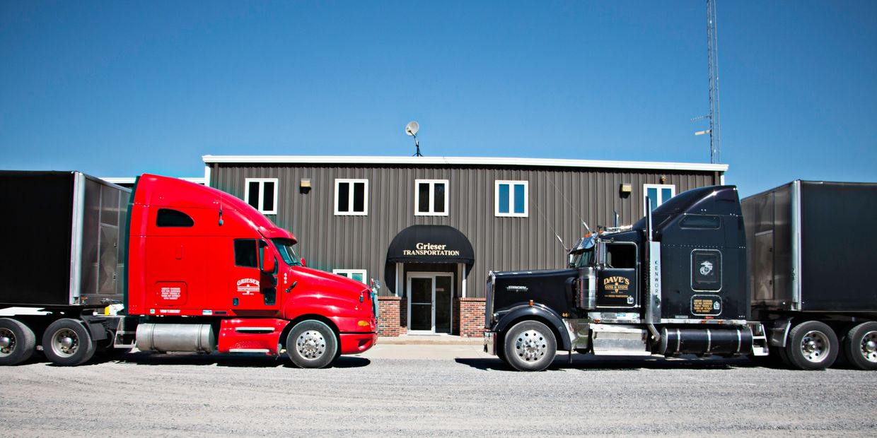 Two of our trucks in front of our shop and office facility.