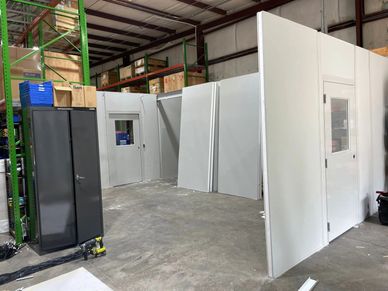 A new grey Modular Office building being constructed inside an industrial setting by SoFlo Installat