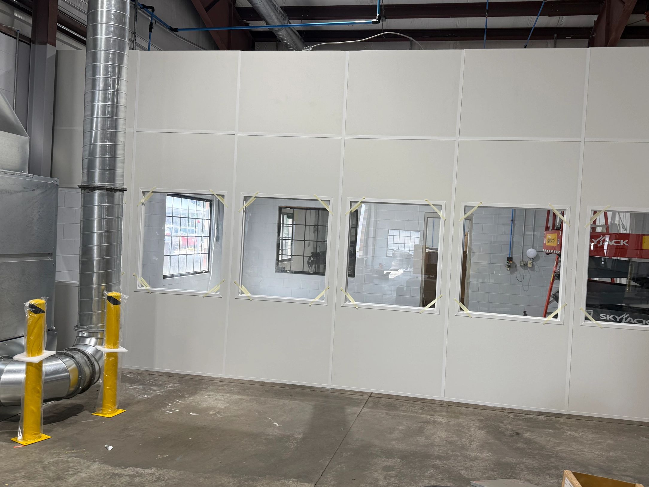 A modular cleanroom or office structure, likely located within a larger industrial building. 
