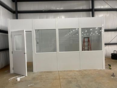 A new white modular in plant prefab building with windows and door in front, nuilt by SoFlo installs