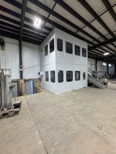 Two story modular office building installation inside a warehouse setting in Manchester CT. By SoFlo