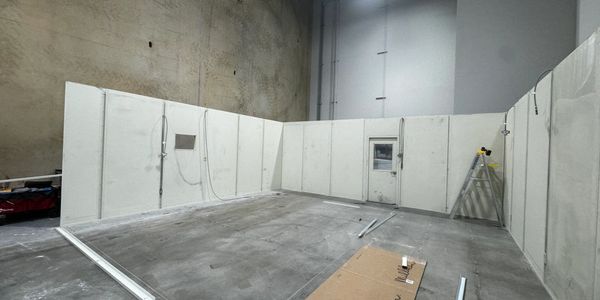 A modular office under construction with a door, AC panel being build by SoFlo Installations 