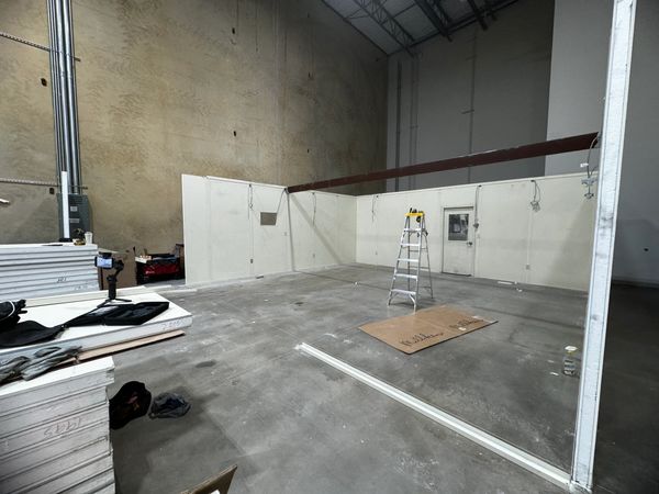 A side view of a newly beige modular office installation constructed by SoFlo inside a warehouse