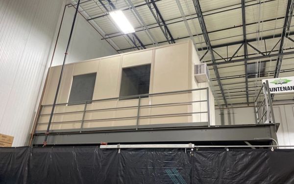 A new modular installation designs on top of a mezzanine with several windows, AC unit by SoFlo inst