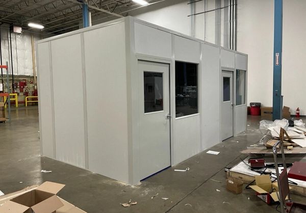 A small grey modular installation designs with several windows, door, by SoFlo installations