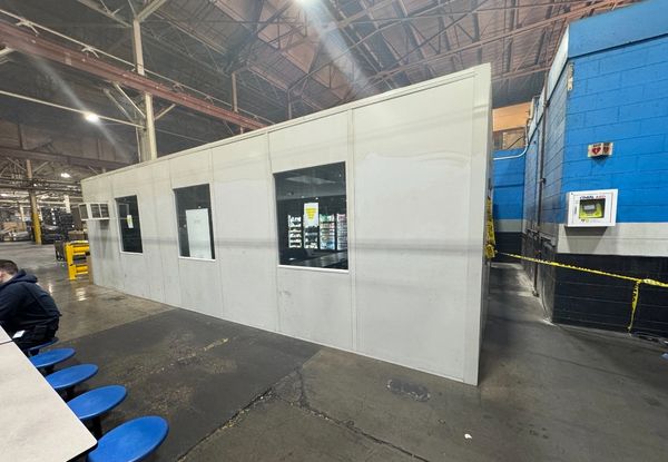 Newly constructed prefab modular rooms with several windows, AC unit by SoFlo installations