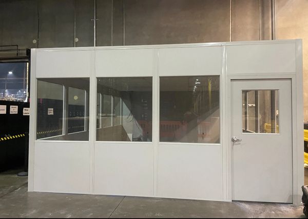 A large white modular office solutions installations by SoFlo installations inside a warehouse setti