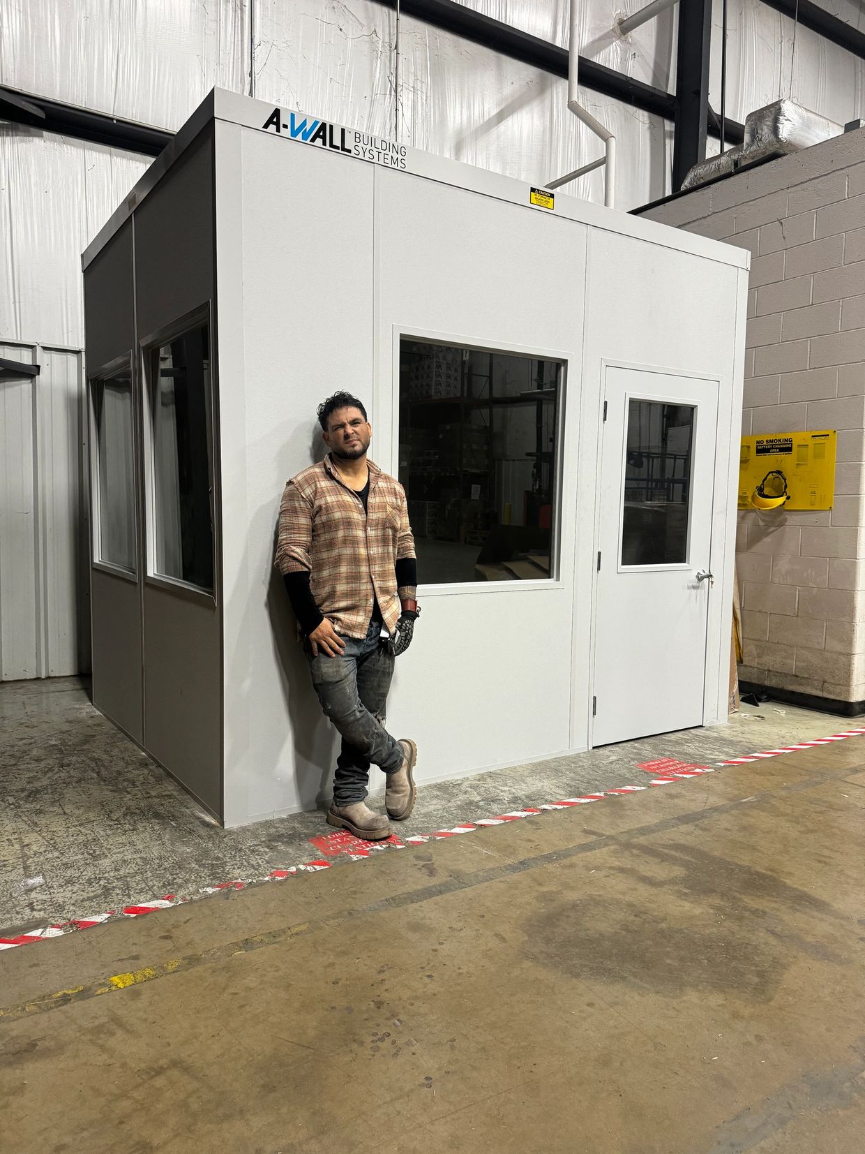 Standing in front of newly constructed modular office from A-Wall building systems & installed by So