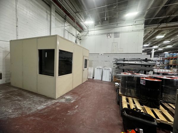 A beige modular installations designs with several windows, door, by SoFlo installations inside a wa