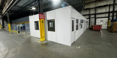 A new white modular office building with several windows, doors built by SoFlo Installations in a wa