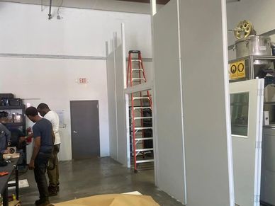 A new custom modular tall wall building inside an industrial setting & machine enclosure by SoFlo In