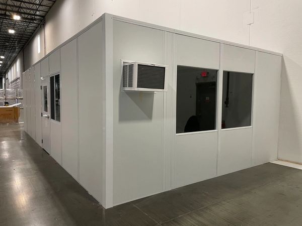 A large modular office solutions installations with several windows, door, AC unit by SoFlo installs