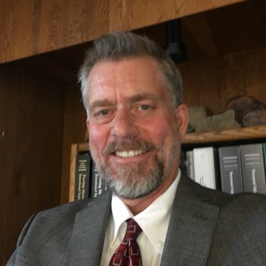 Smiling man in a suit and tie.