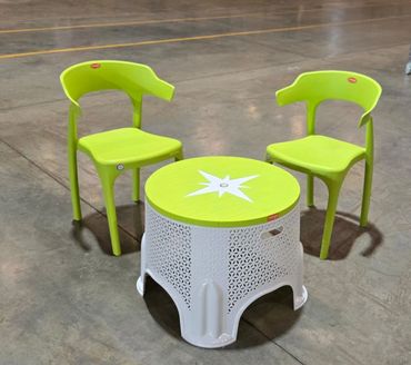 Two green chairs and a white table with a green top.