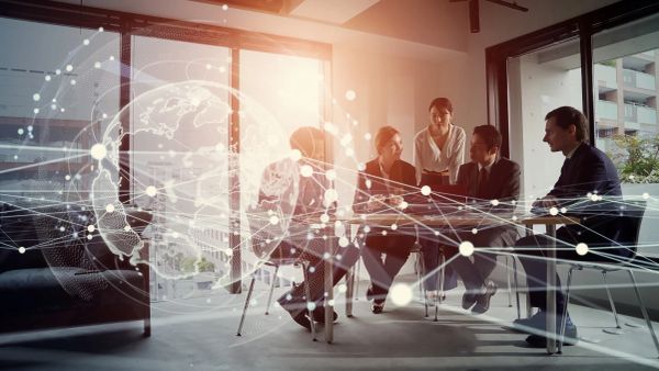Business team collaborating with digital network overlay in modern office.