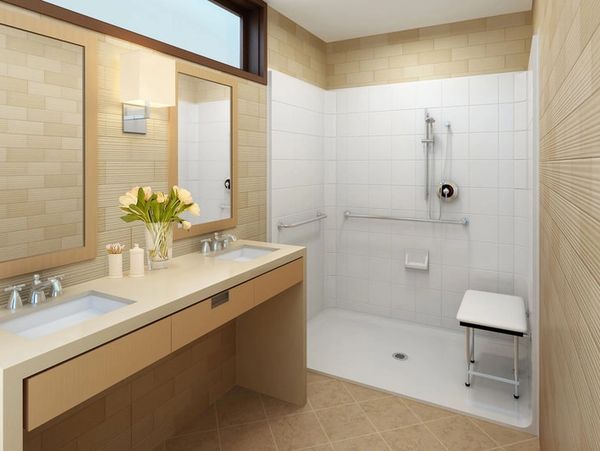 Modern accessible bathroom with dual sinks and walk-in shower with bench.
