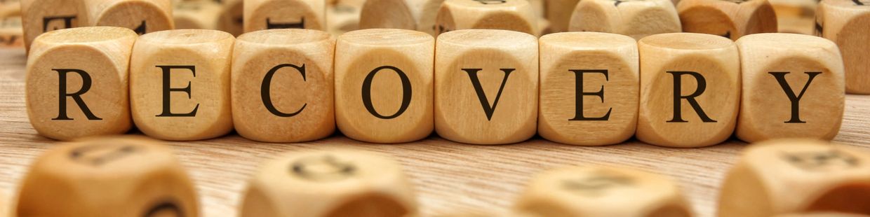 Wooden blocks spelling RECOVERY.